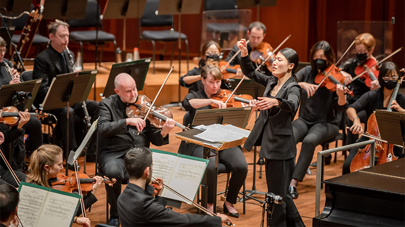 Orchestra players with Carlin Ma